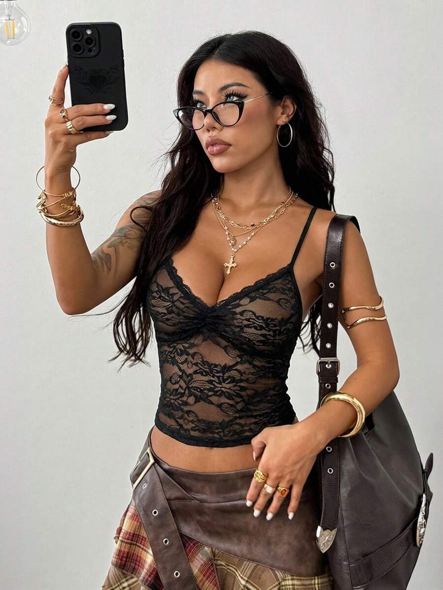 Women's black lace cami crop top featuring spaghetti straps, semi-sheer plant pattern fabric, and a backless design.