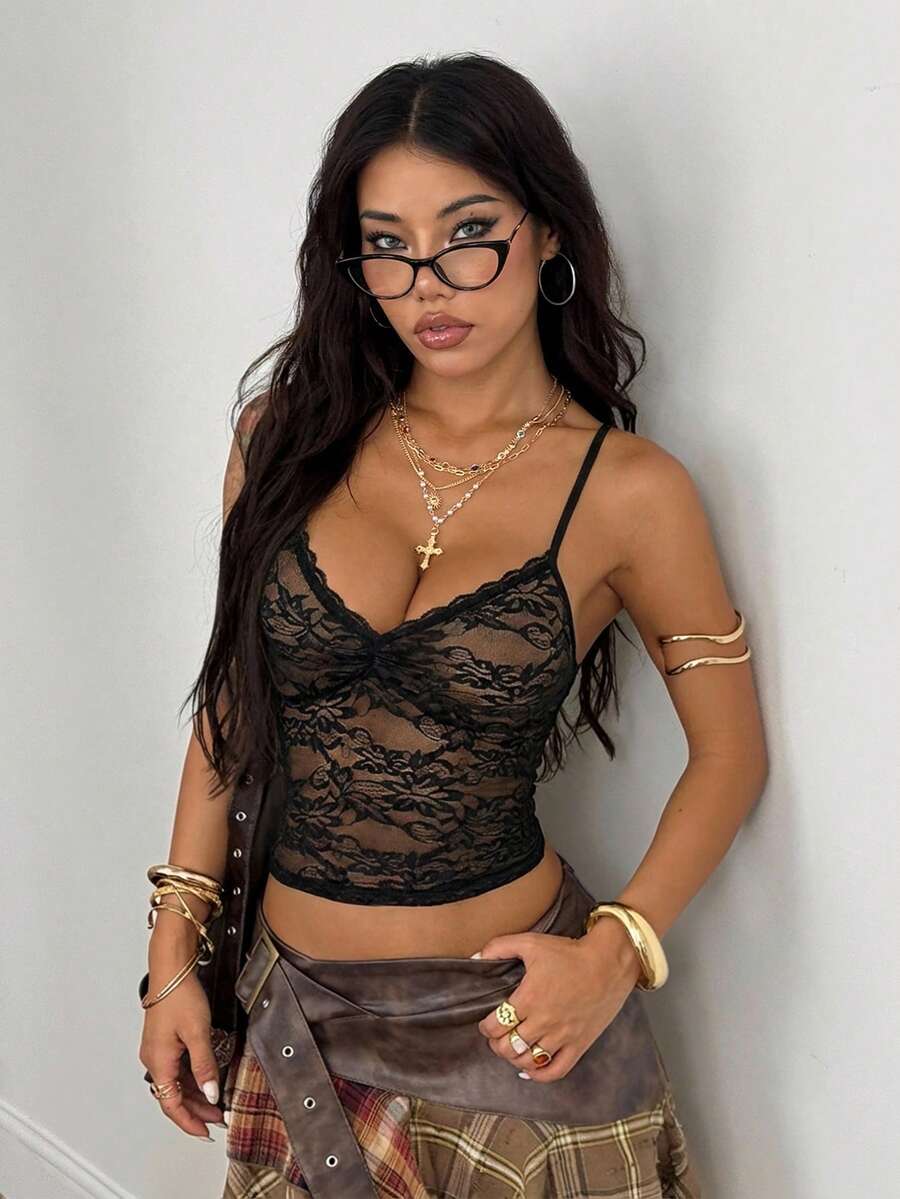 Women's black lace cami crop top featuring spaghetti straps, semi-sheer plant pattern fabric, and a backless design.