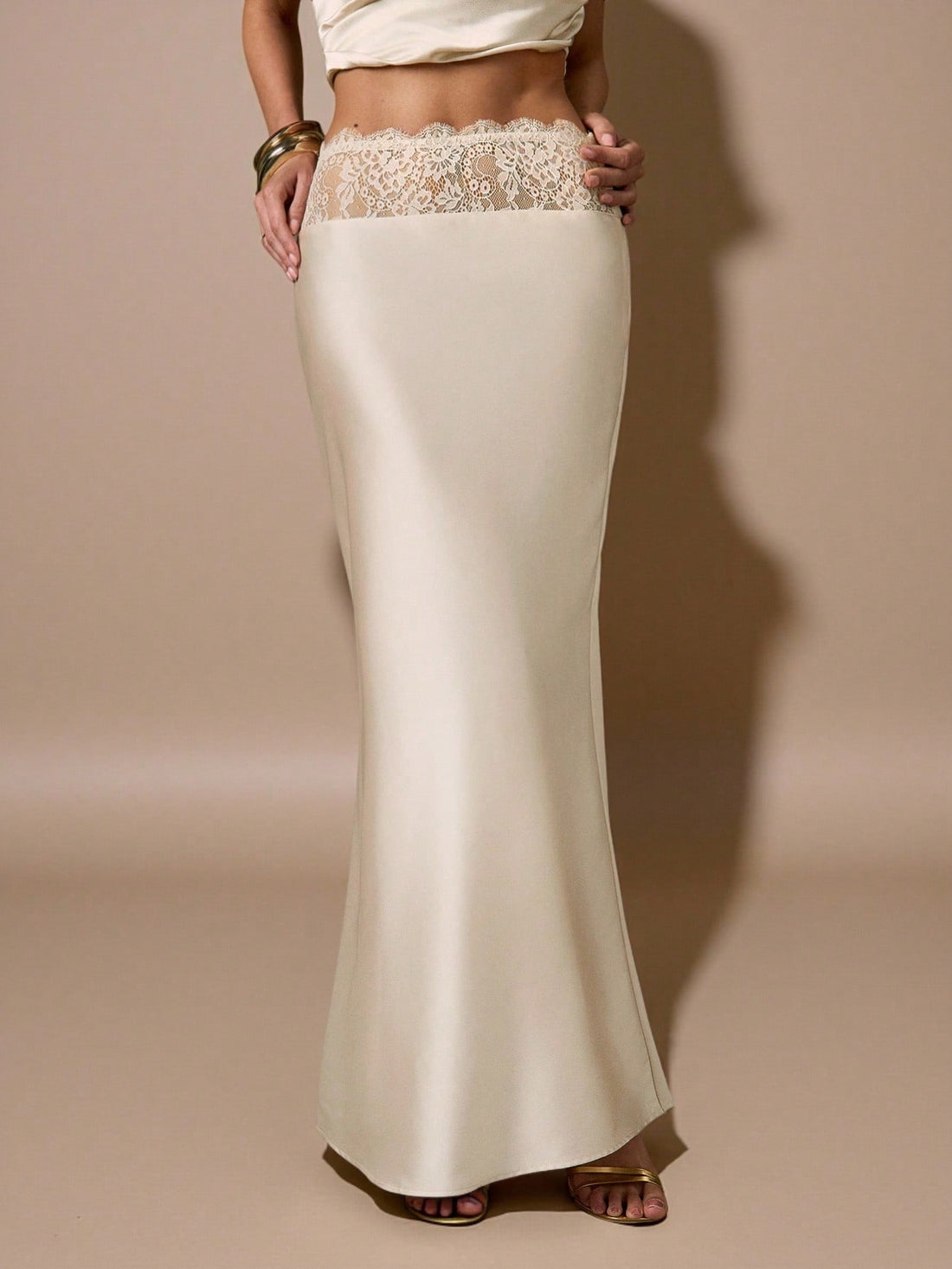 Apricot satin mermaid maxi skirt for women featuring contrast lace patchwork, ruched detailing, and a zipper closure.