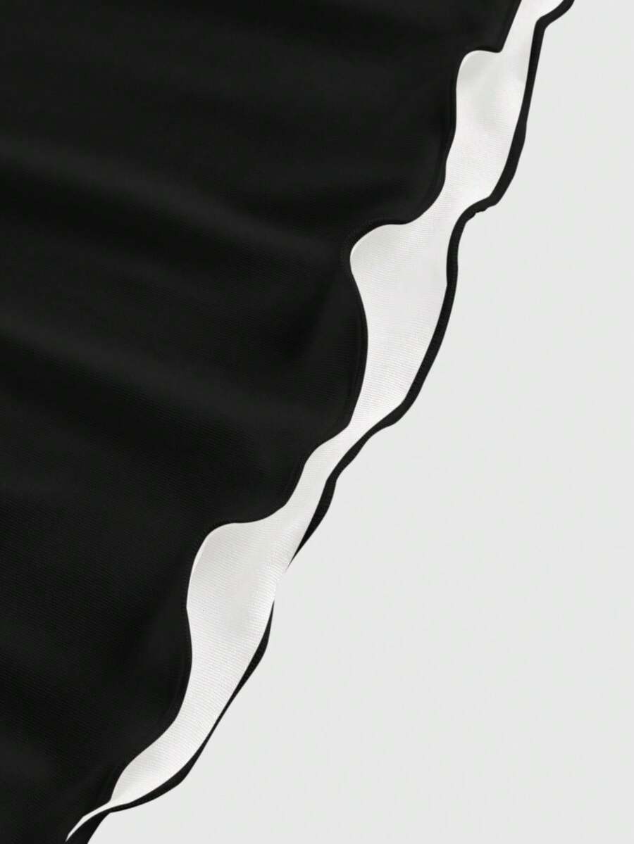 Women's black backless cami mini dress featuring spaghetti straps, lettuce trim, and a flared hem in high stretch knitted fabric.