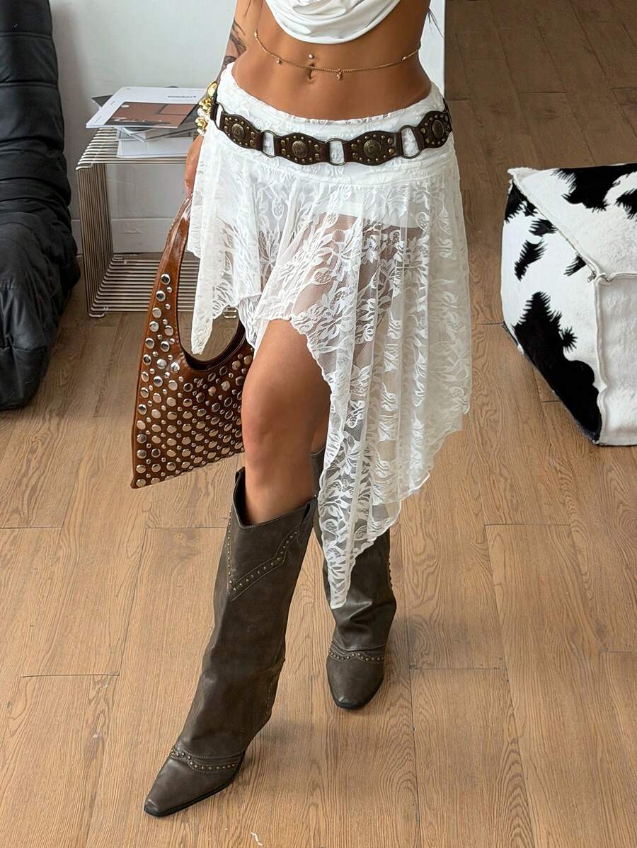 Women's asymmetrical ruffle skort with low waist, hollow out details, and lined body in knitted stretch fabric for beach and summer wear.