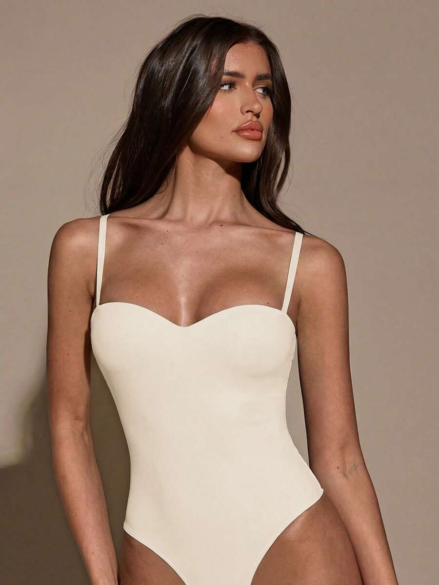 Apricot women's lace sheer camisole top featuring spaghetti straps, contrast lace trim, backless slim fit design, and knitted stretch fabric.