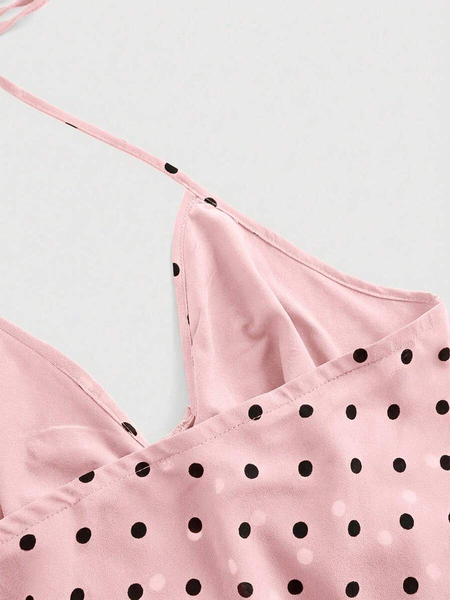 Black halter crop top featuring an asymmetrical ruffle hem and backless design for women.