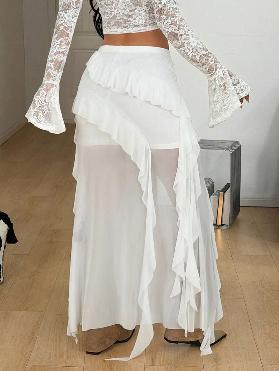 Women's low rise asymmetrical long skirt with tiered ruffle details in stretch knitted fabric.