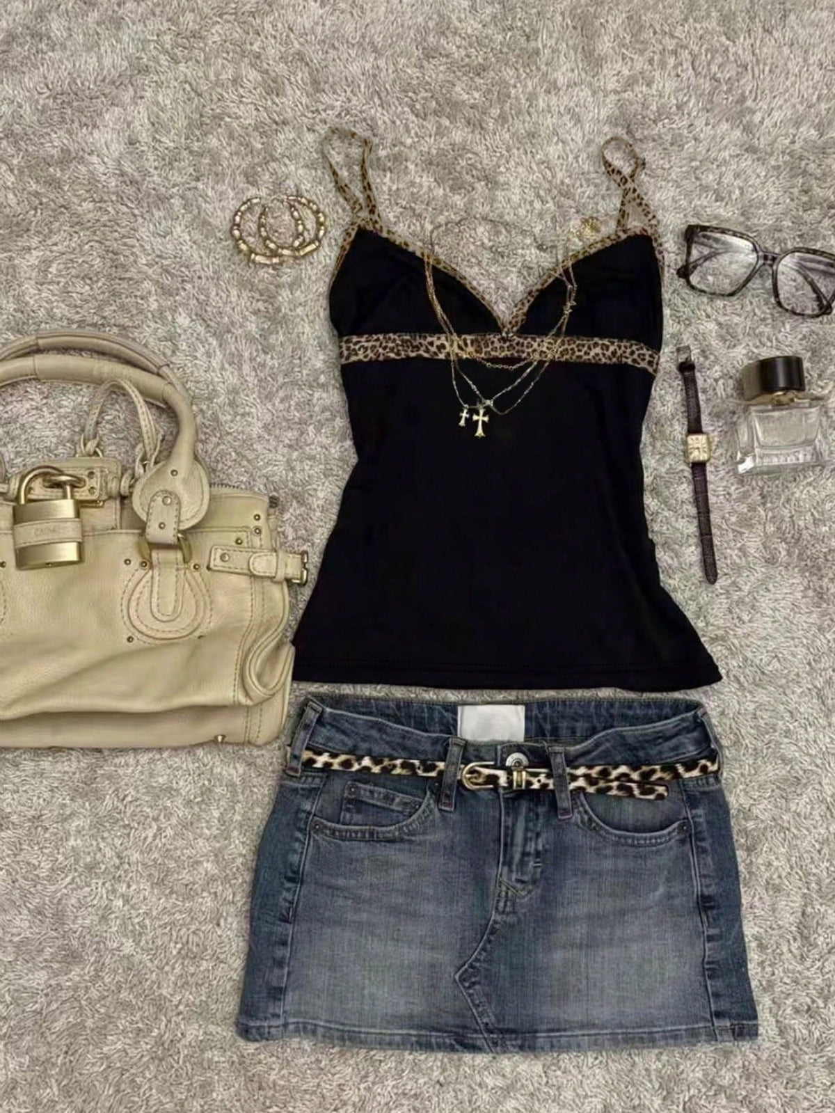 A women's solid slim fit camisole top with delicate contrast lace trim around the neckline and spaghetti straps.