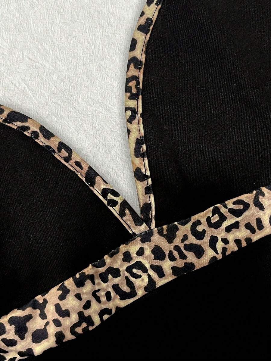 A women's solid slim fit camisole top with delicate contrast lace trim around the neckline and spaghetti straps.
