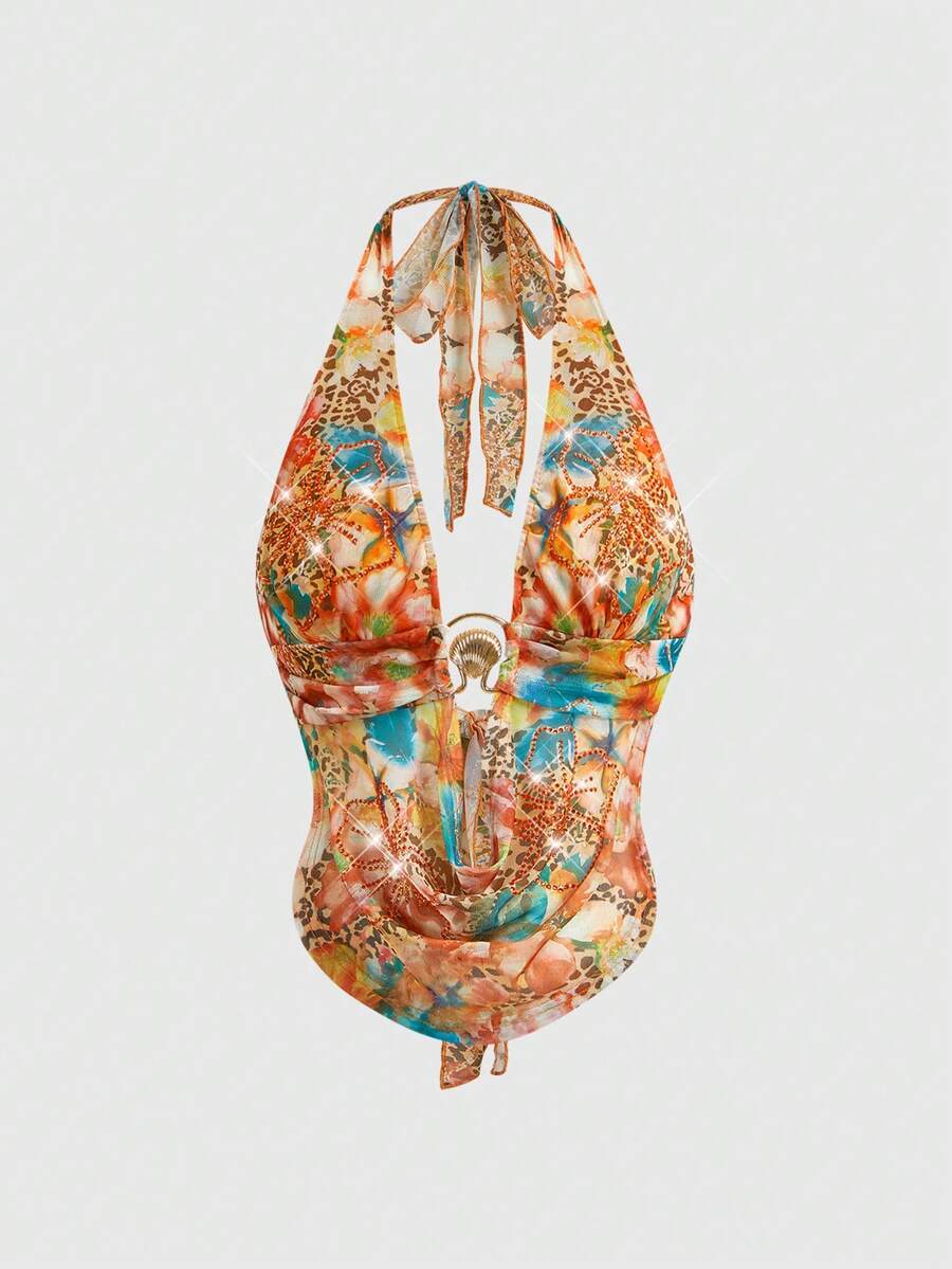 Women's pink backless halter top with rhinestone decor, knot detail, and asymmetrical hem.