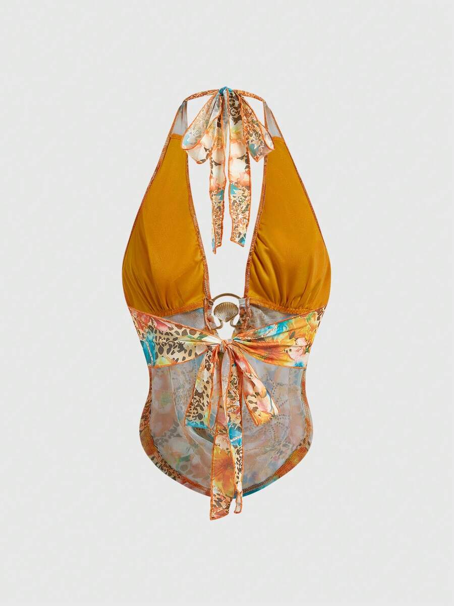 Women's pink backless halter top with rhinestone decor, knot detail, and asymmetrical hem.