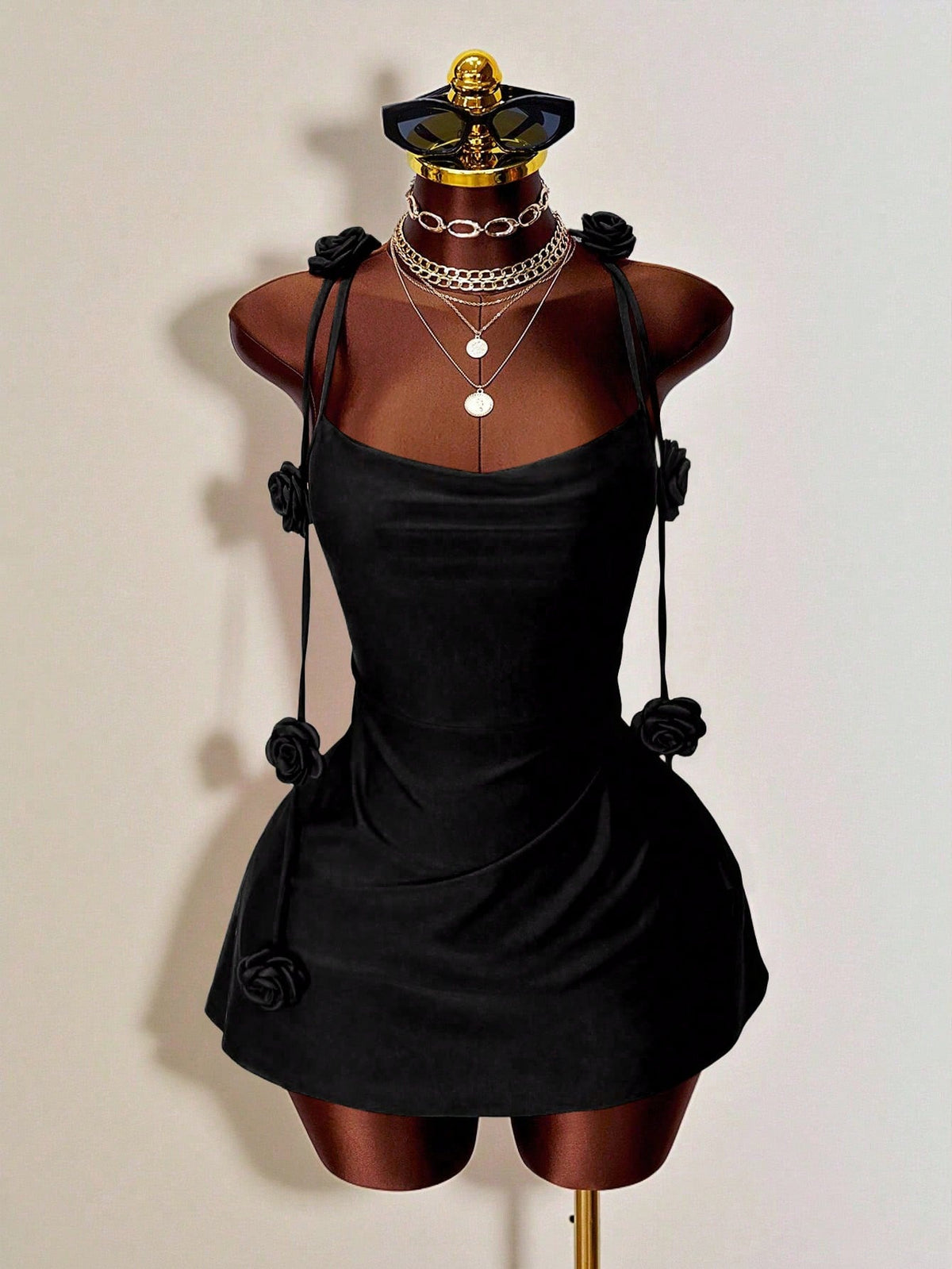 Women's bodycon mini dress featuring a 3D rose accent, thin spaghetti straps, and an open back design.