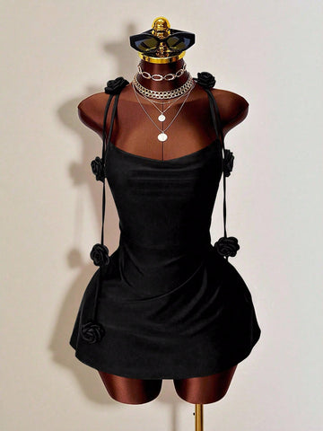 Women's bodycon mini dress featuring a 3D rose accent, thin spaghetti straps, and an open back design.