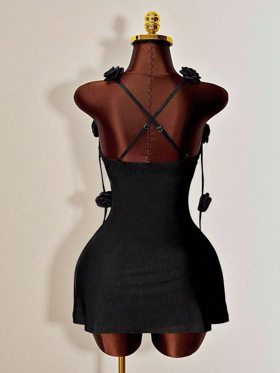 Women's bodycon mini dress featuring a 3D rose accent, thin spaghetti straps, and an open back design.