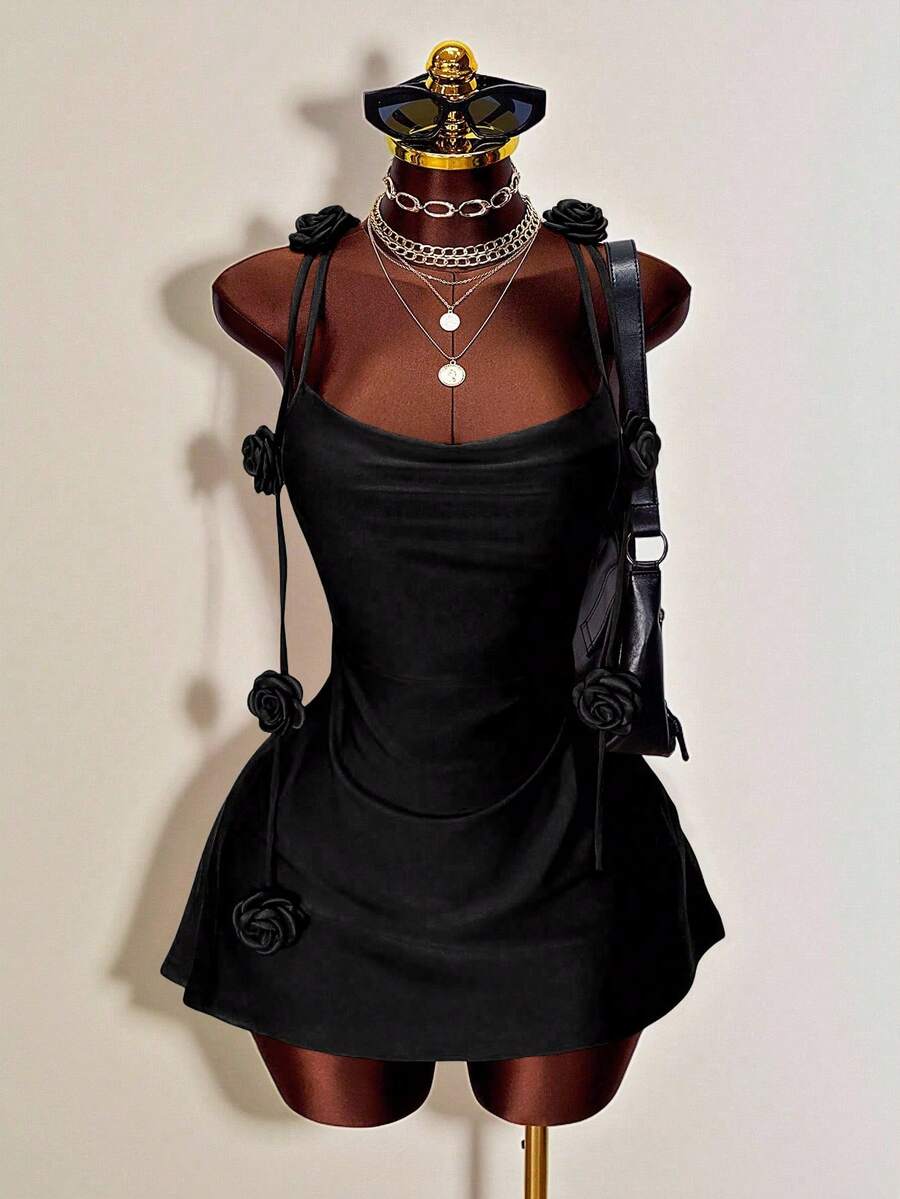 Women's bodycon mini dress featuring a 3D rose accent, thin spaghetti straps, and an open back design.