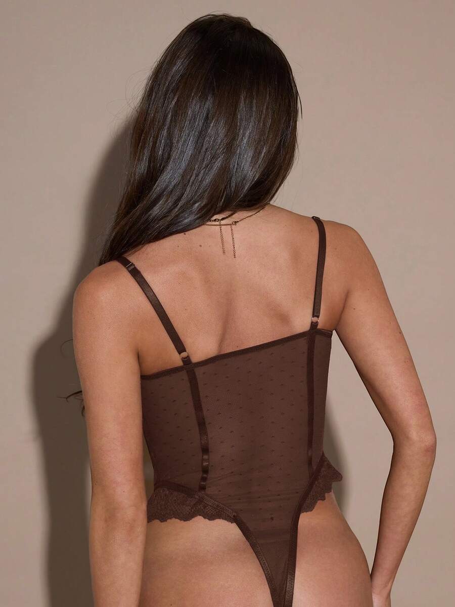 Women's slim fit contrast lace cami bodysuit featuring thin spaghetti straps and asymmetrical detailing.