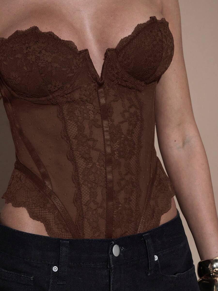 Women's slim fit contrast lace cami bodysuit featuring thin spaghetti straps and asymmetrical detailing.