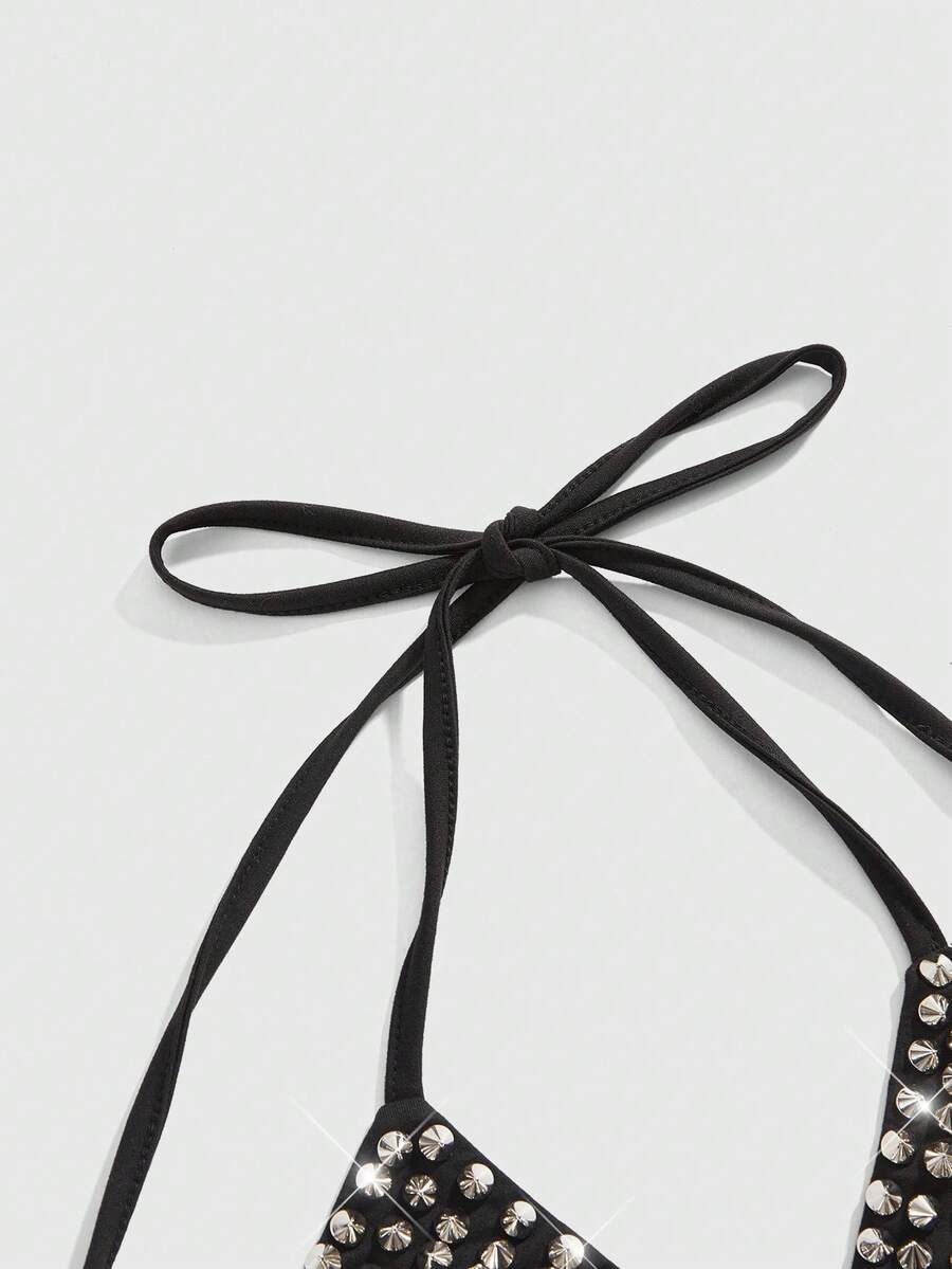 Black studded halter bikini top featuring a backless lace-up design, rhinestone accents, and high-stretch knitted fabric.