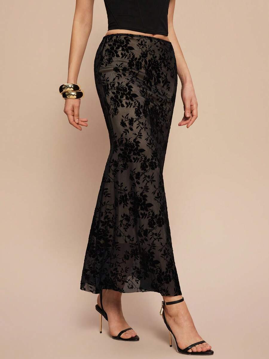 Women's black lace long mermaid skirt featuring lettuce trim, ruffle hem, random print pattern, low waist, and zipper detail.