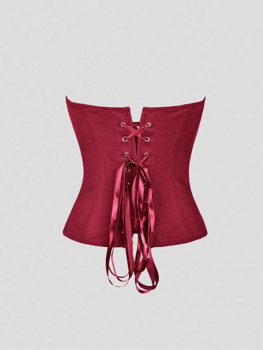 Black strapless corset top with boning, lace-up back, and a cropped slim-fit silhouette for women.