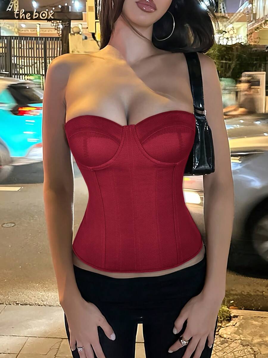 Black strapless corset top with boning, lace-up back, and a cropped slim-fit silhouette for women.