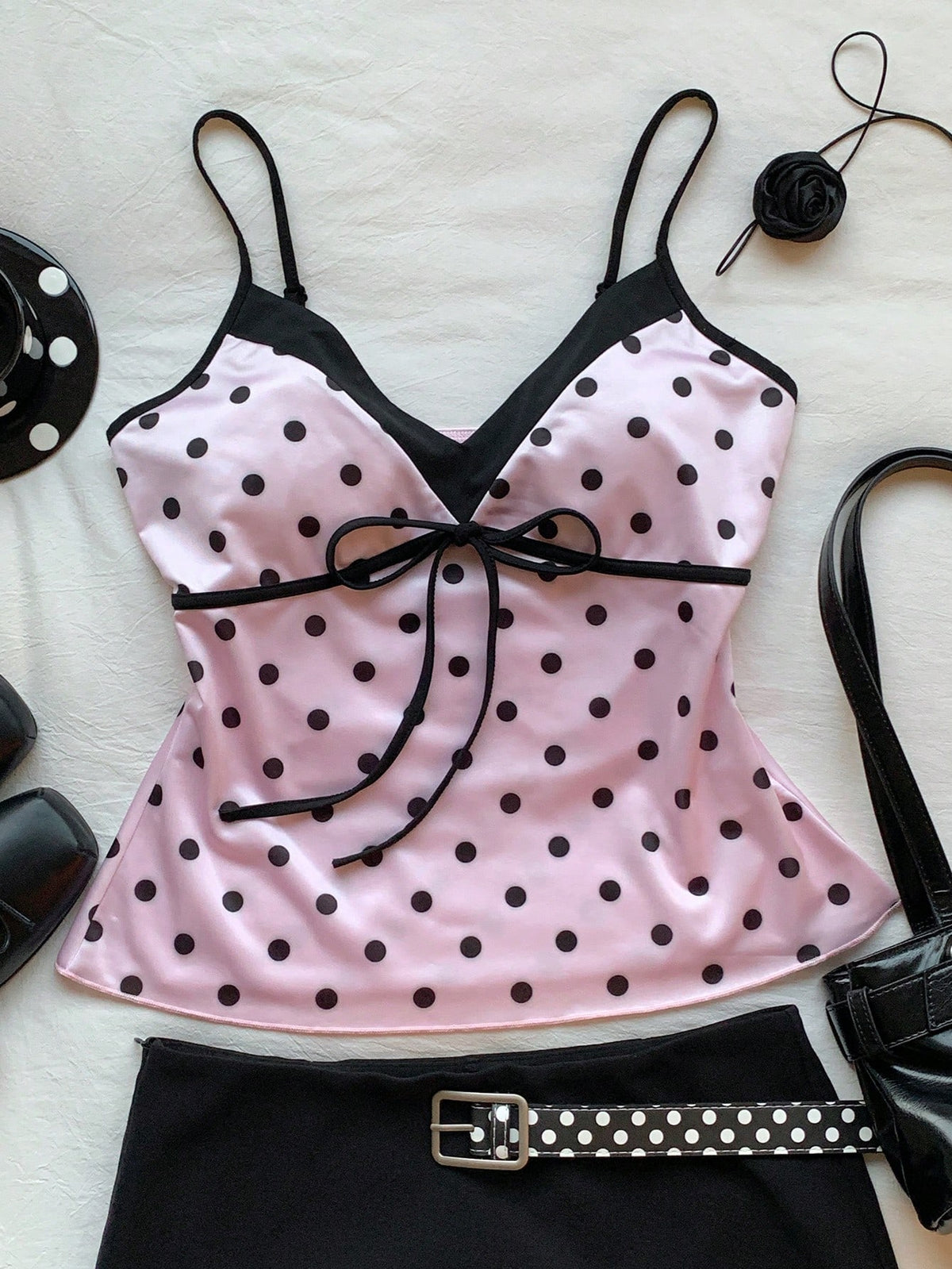 Black and white polka dot tie strap camisole top for women with thin spaghetti straps and slim fit.