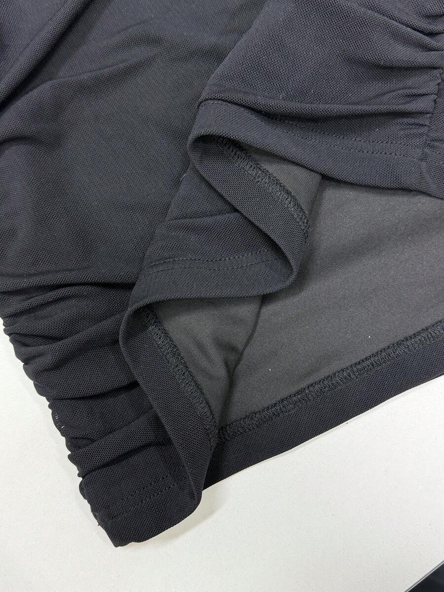 Women wearing a black halter bodycon mini dress with ruched draped detailing and a backless design made of high stretch knitted fabric.