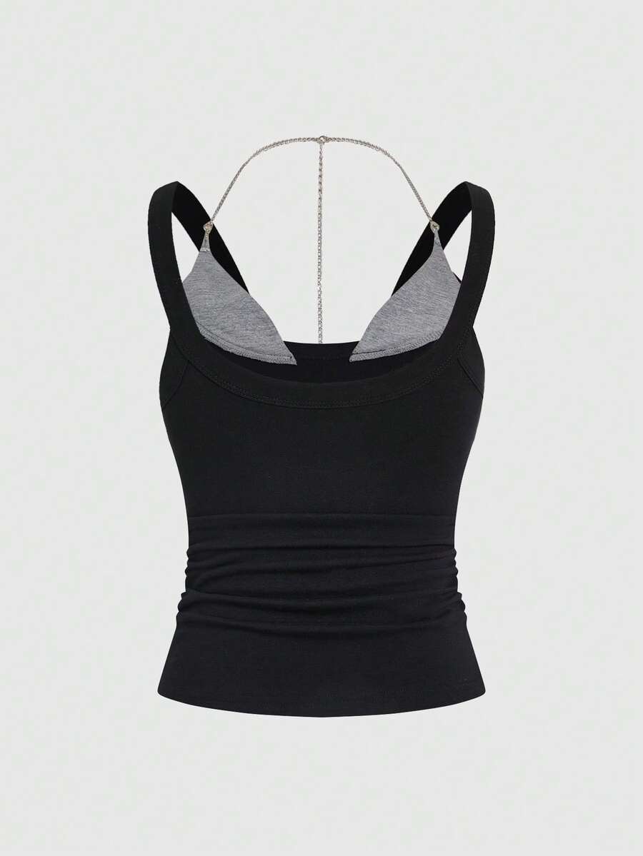 Backless grommet cami tank top featuring slim fit silhouette and strap details on knitted fabric