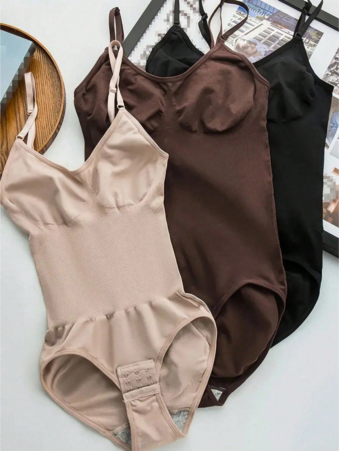 3-pack women's seamless body shaper bodysuits featuring adjustable wide shoulder straps, tummy control panel, snap crotch closure, and plain knitted fabric.