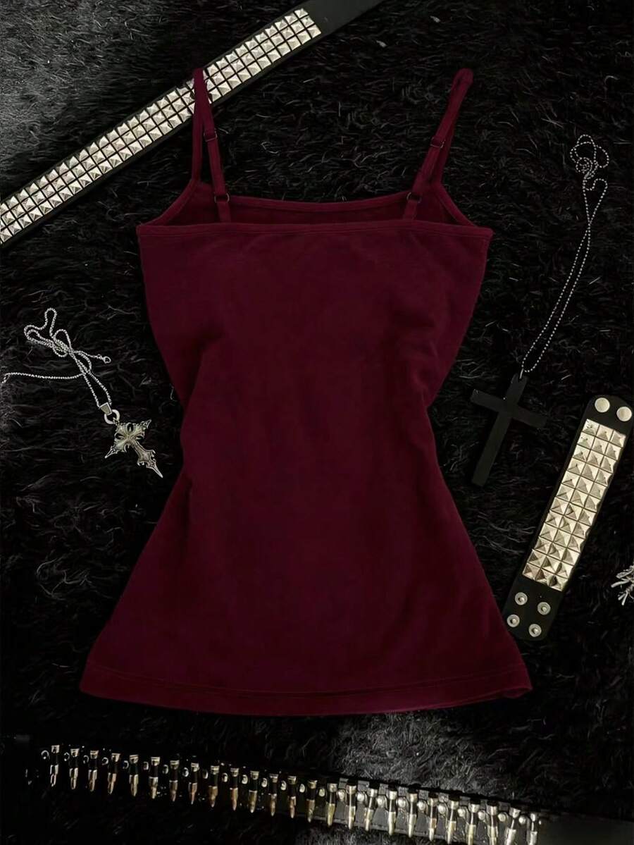 Burgundy cross pattern camisole top featuring spaghetti straps, ring accent, and a backless slim fit design.