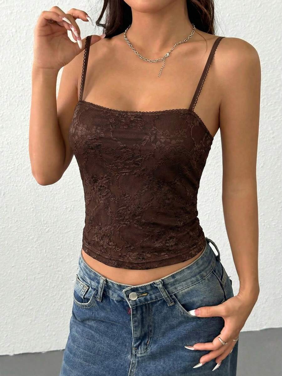Women's white lace crop camisole top featuring spaghetti straps and slim fit design.