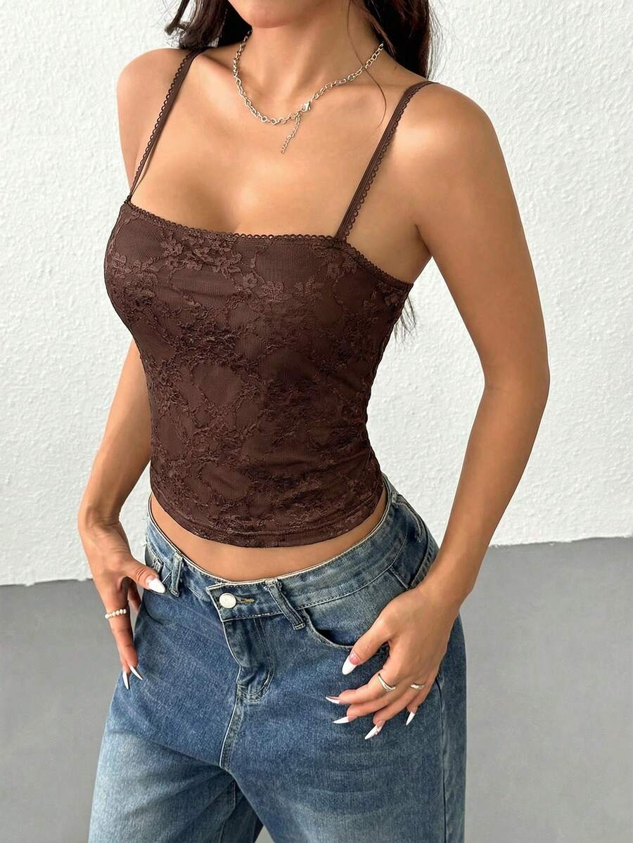 Women's white lace crop camisole top featuring spaghetti straps and slim fit design.