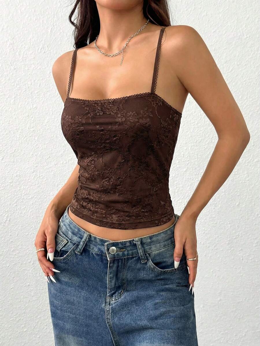 Women's white lace crop camisole top featuring spaghetti straps and slim fit design.