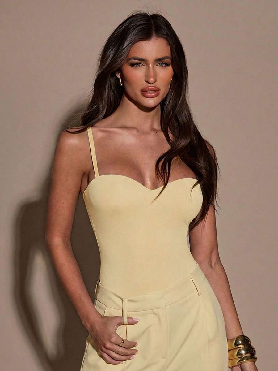 Apricot women's lace sheer camisole top featuring spaghetti straps, contrast lace trim, backless slim fit design, and knitted stretch fabric.