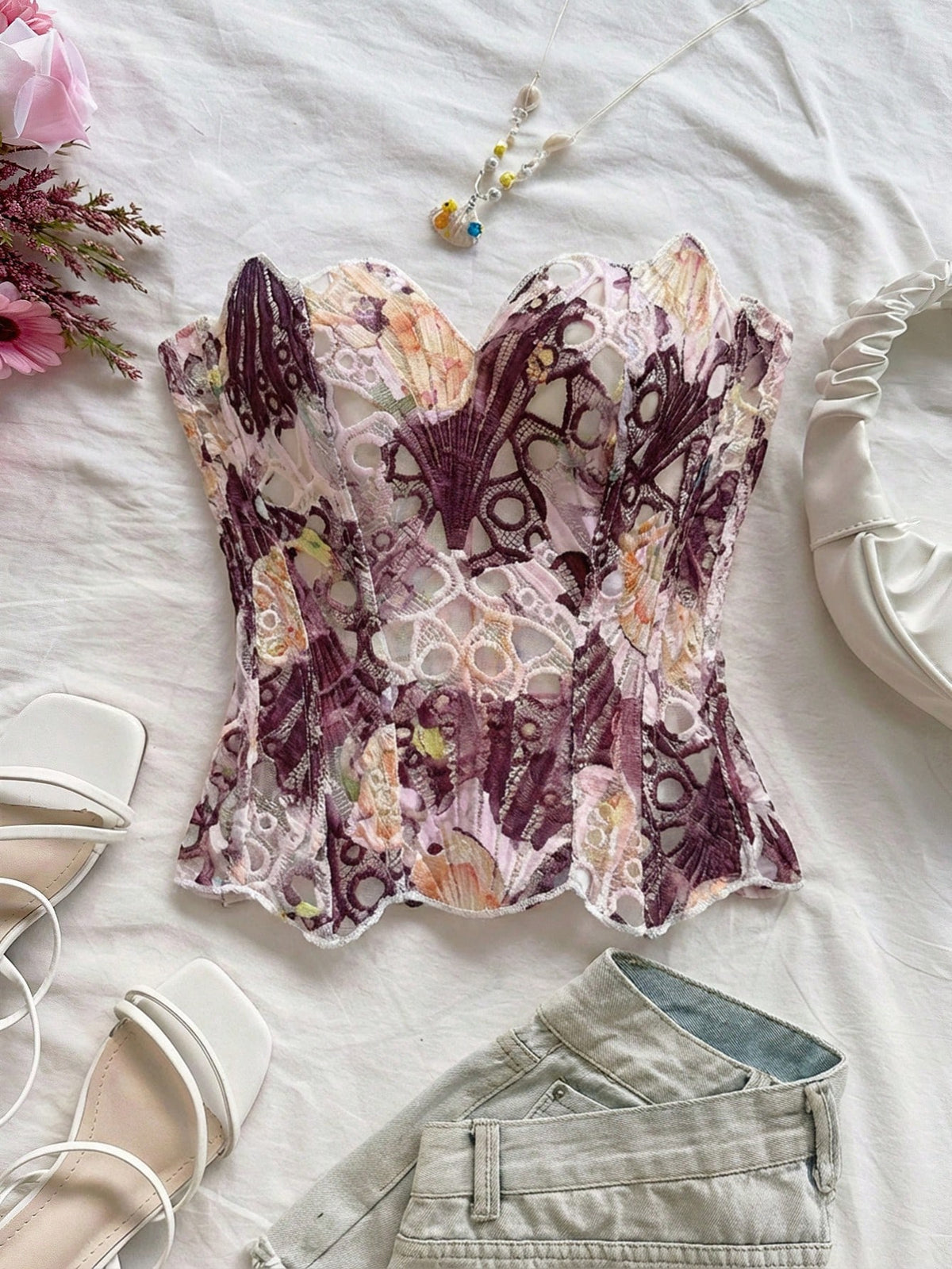 Strapless floral corset top with lace-up detail, asymmetrical hem, and slim fit for women in a boho vacation style.