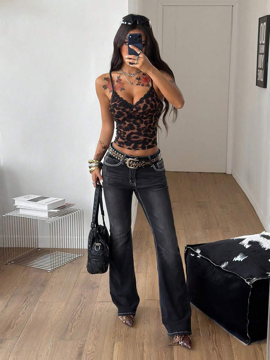 Women's black lace cami crop top featuring spaghetti straps, semi-sheer plant pattern fabric, and a backless design.