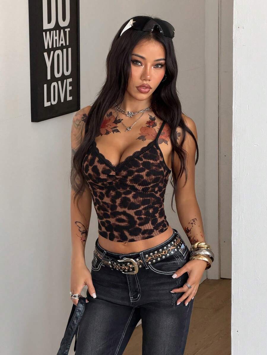 Women's black lace cami crop top featuring spaghetti straps, semi-sheer plant pattern fabric, and a backless design.