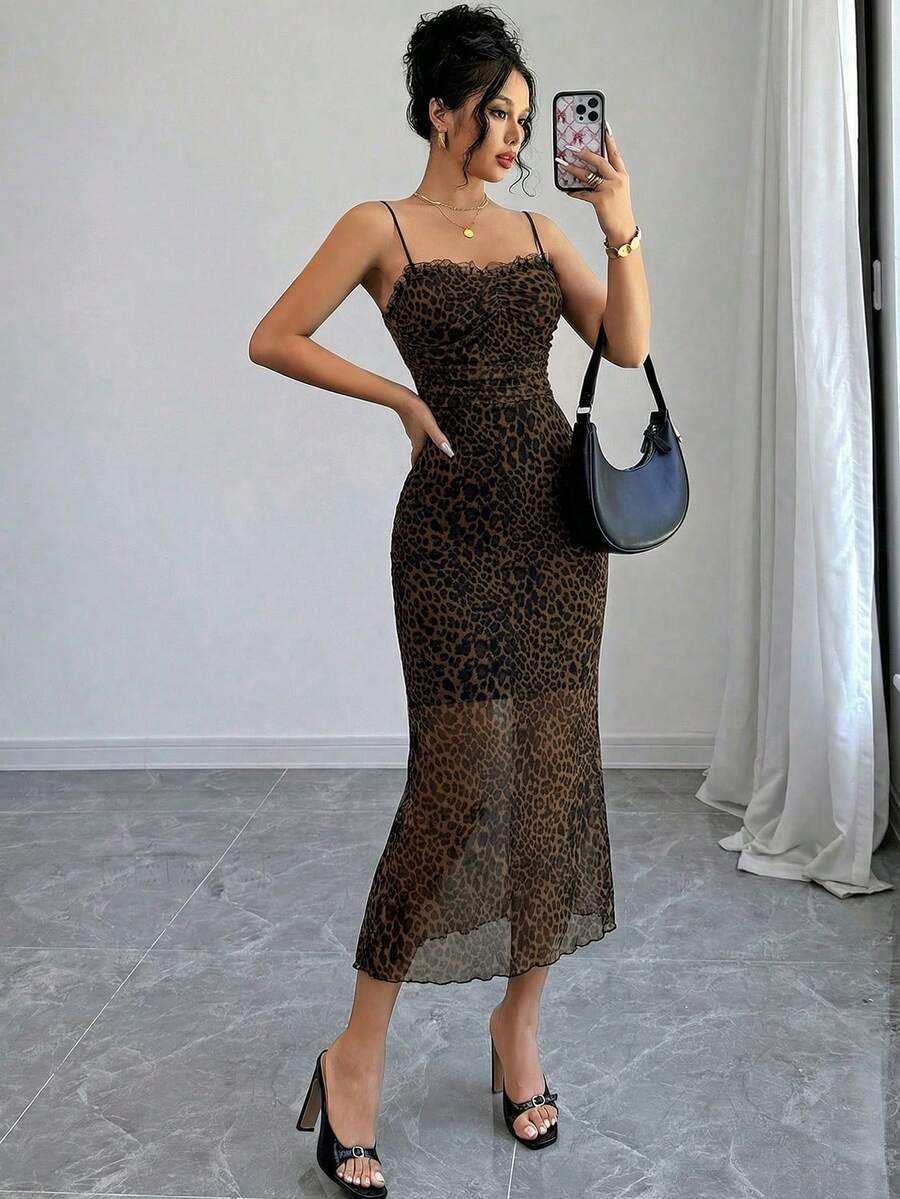 Women wearing a brown leopard print midi cami dress with spaghetti straps, backless detail, and a side split thigh.