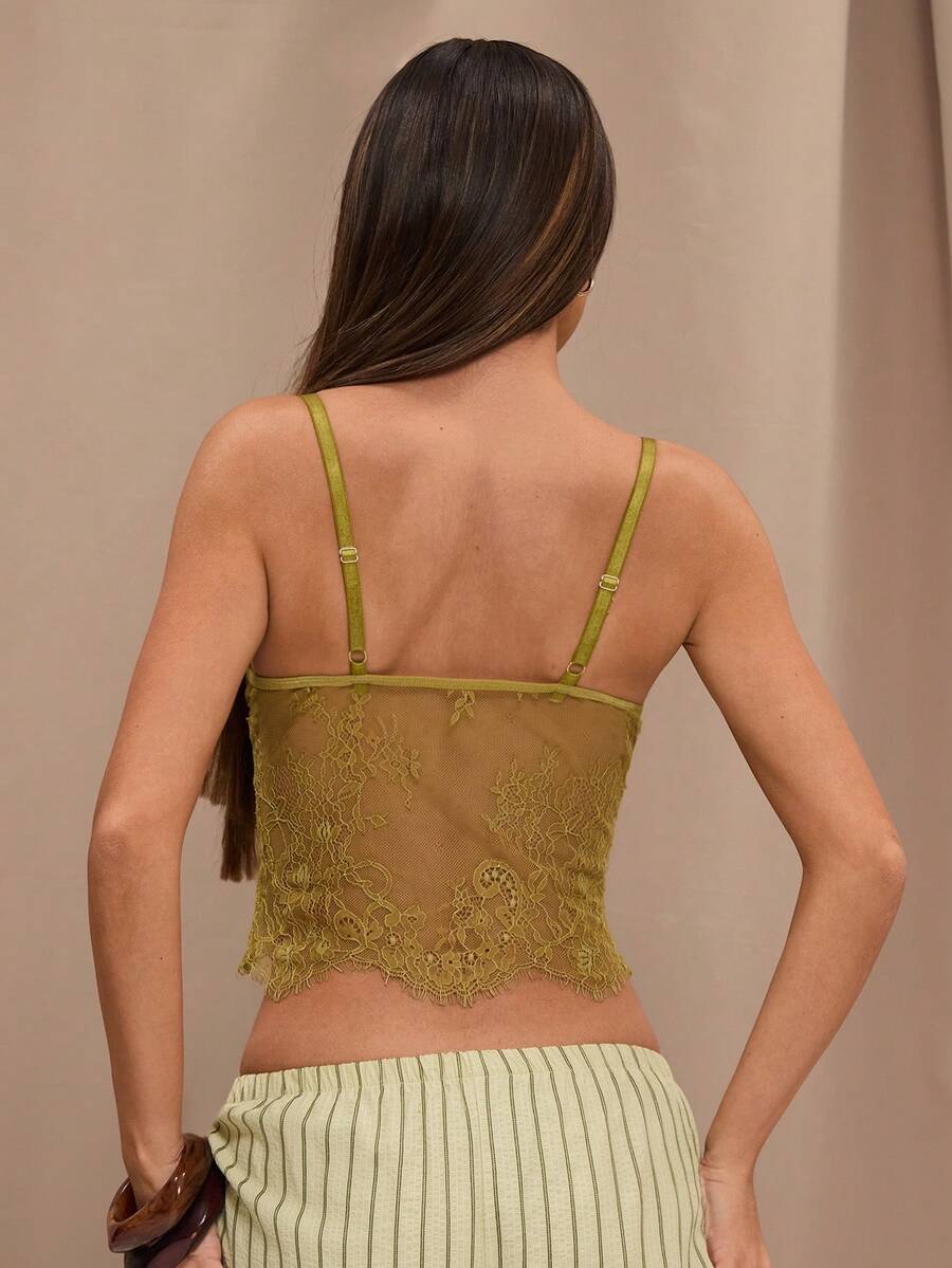 Black floral lace cropped camisole top for women featuring delicate spaghetti straps, cup detail, and semi-sheer contrast lace.