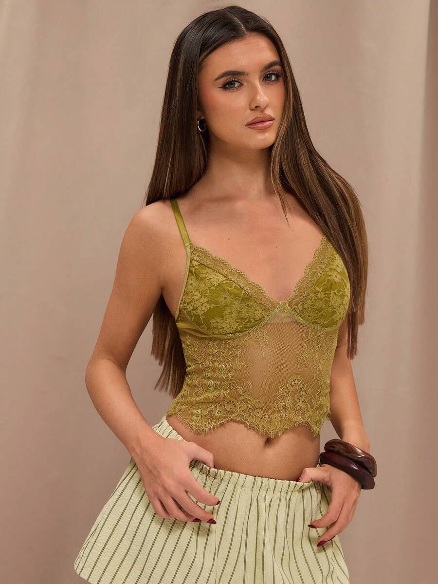 Black floral lace cropped camisole top for women featuring delicate spaghetti straps, cup detail, and semi-sheer contrast lace.