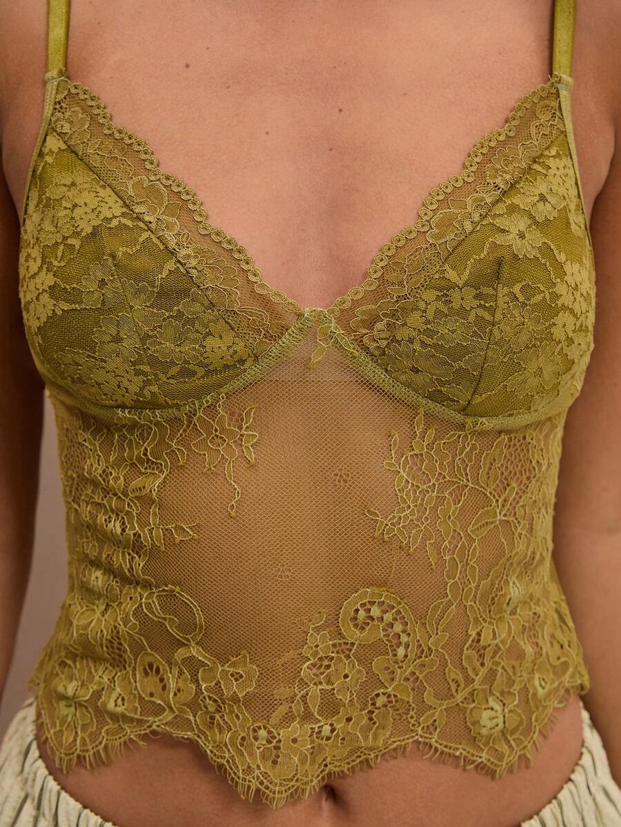 Black floral lace cropped camisole top for women featuring delicate spaghetti straps, cup detail, and semi-sheer contrast lace.