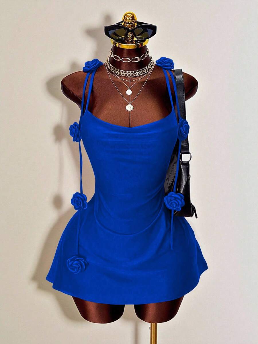 Women's bodycon mini dress featuring a 3D rose accent, thin spaghetti straps, and an open back design.