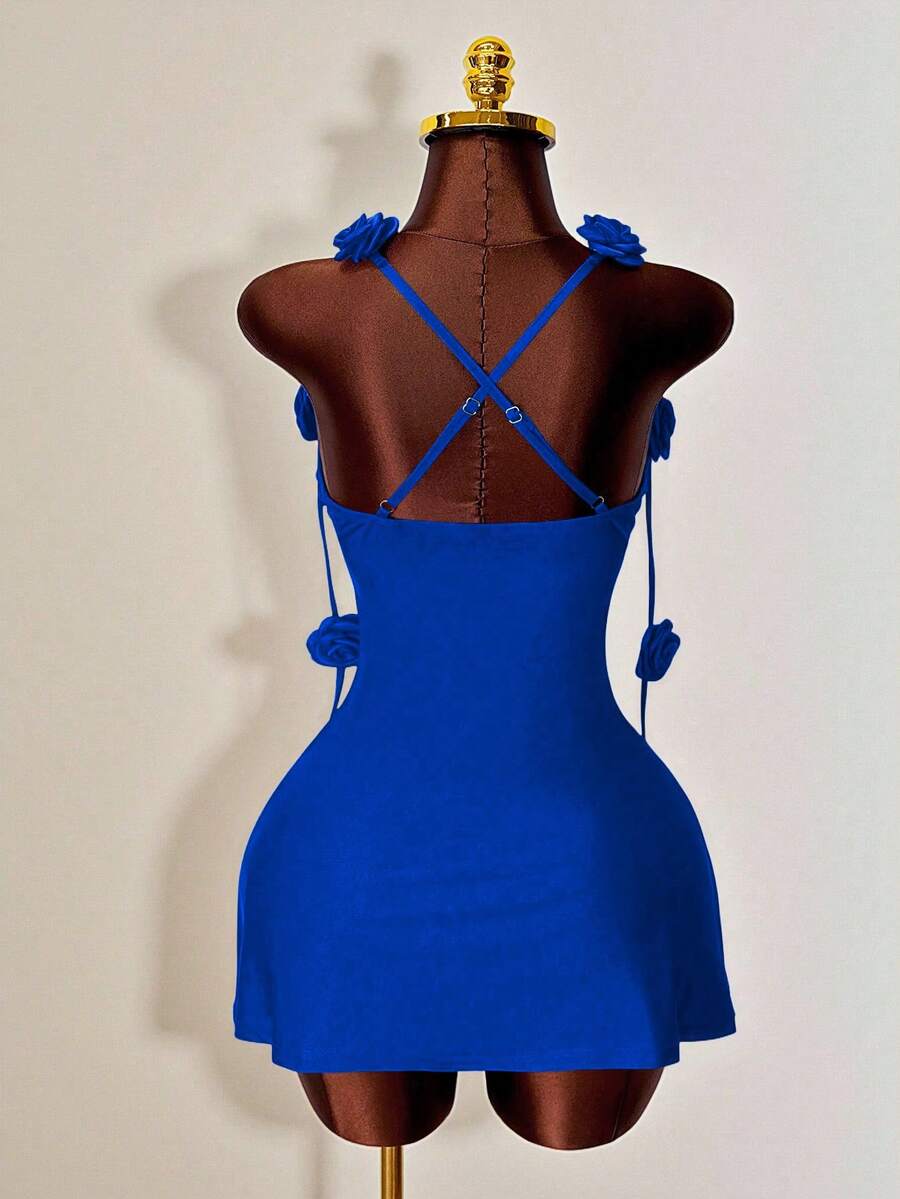 Women's bodycon mini dress featuring a 3D rose accent, thin spaghetti straps, and an open back design.