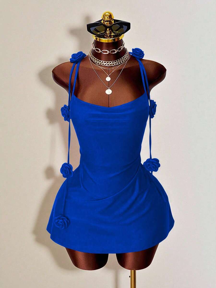 Women's bodycon mini dress featuring a 3D rose accent, thin spaghetti straps, and an open back design.