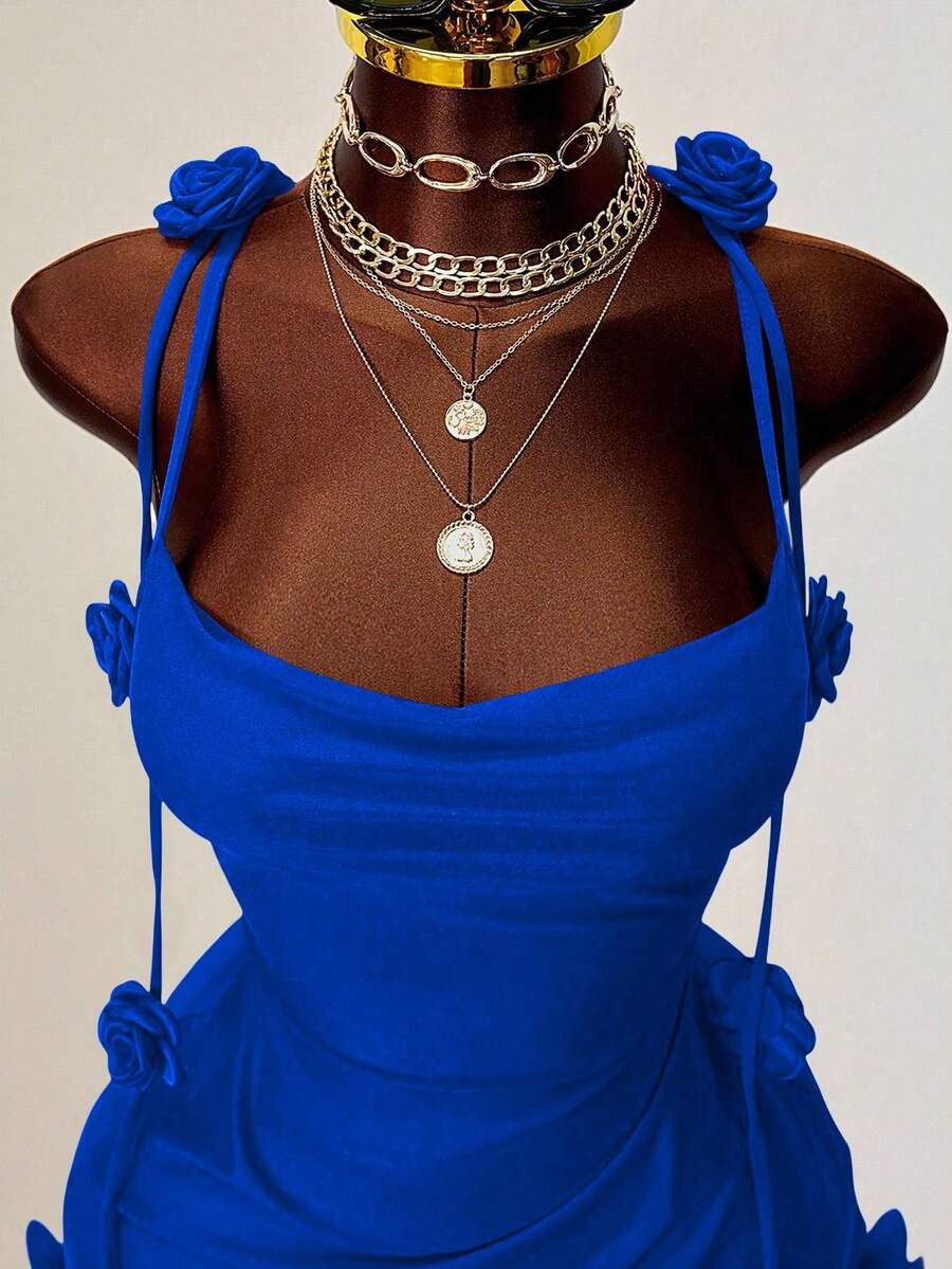 Women's bodycon mini dress featuring a 3D rose accent, thin spaghetti straps, and an open back design.
