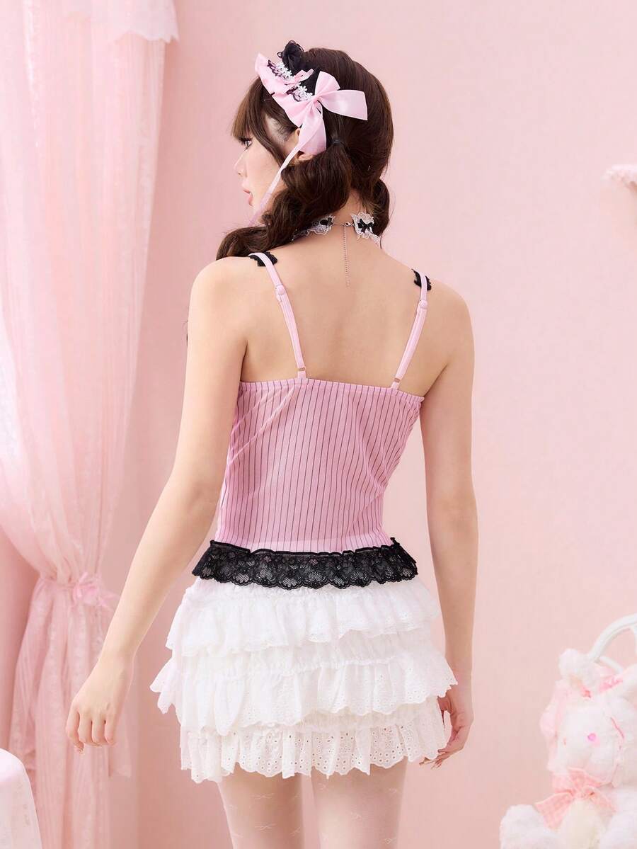Pink slim fit camisole for women featuring contrast lace patchwork, bow detail, rhinestone accents, and spaghetti straps in mesh fabric.