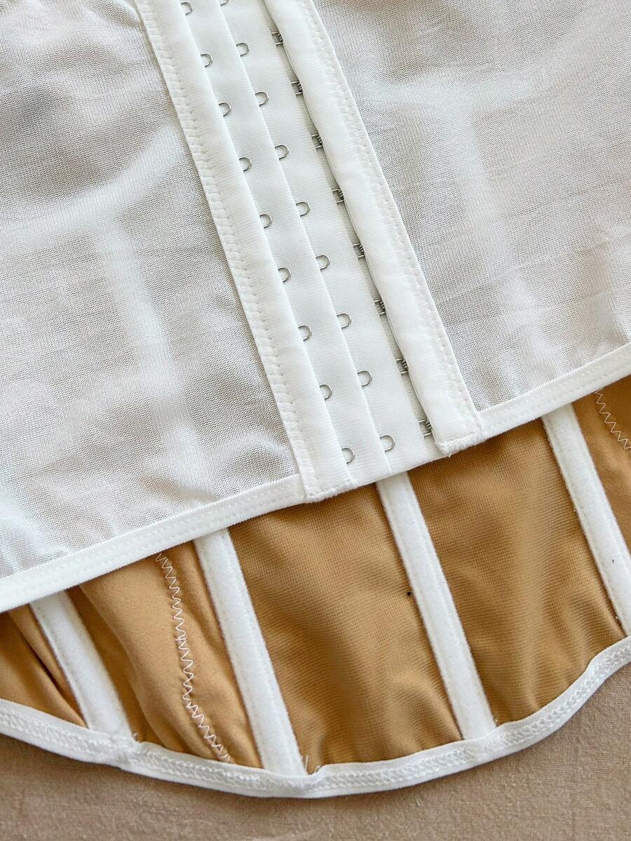 Women's lace bustier camisole top with spaghetti straps, contrast lace, lace-up detail, and an asymmetrical hem in a slim fit design.