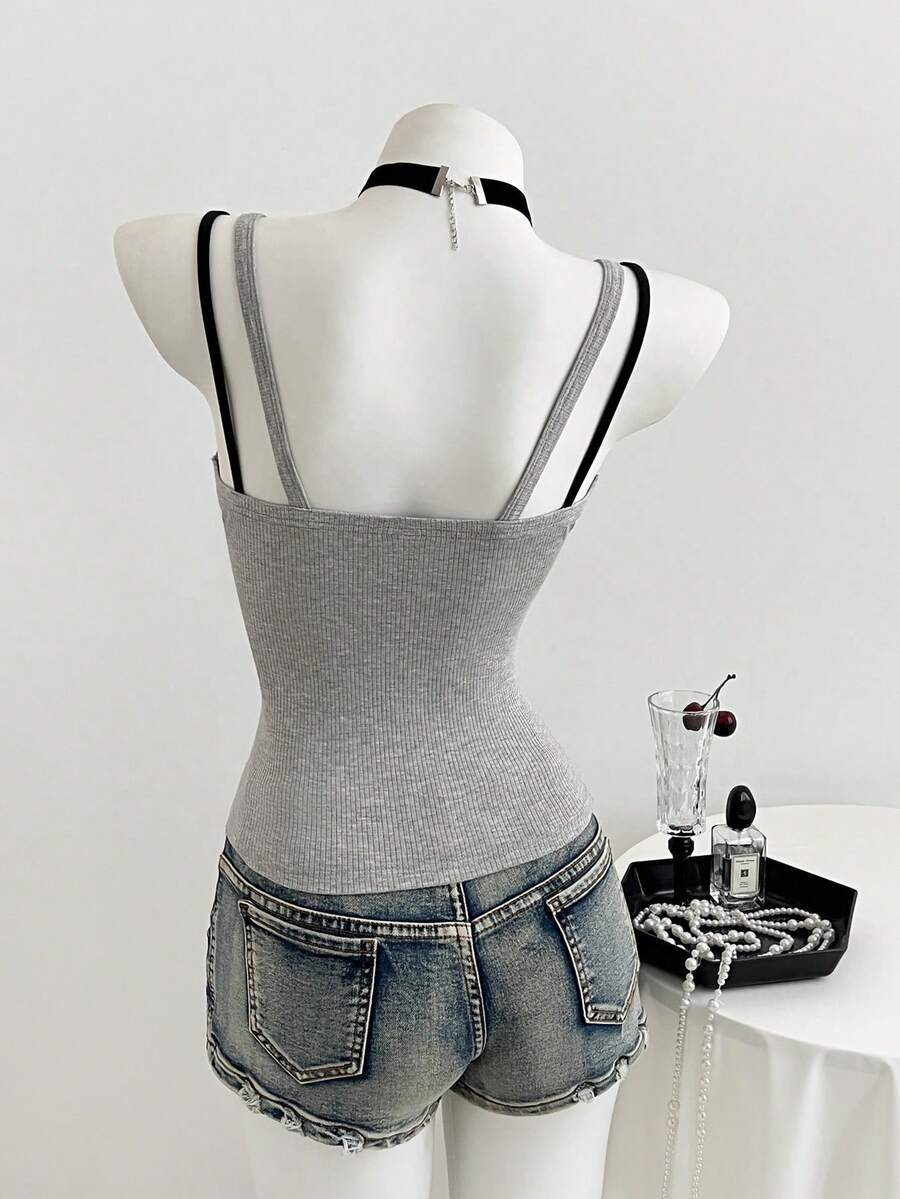 Women's slim fit spaghetti strap cami tank top with contrast lace trim along the neckline