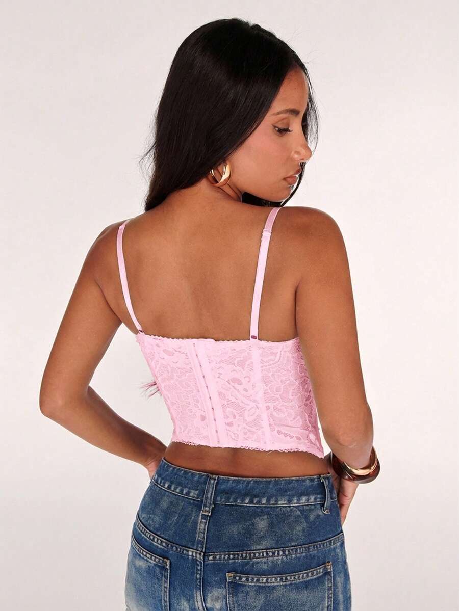 Black women’s lace cami top with spaghetti straps, contrast lace details, and an asymmetrical hem, styled as a slim-fit lined casual top.