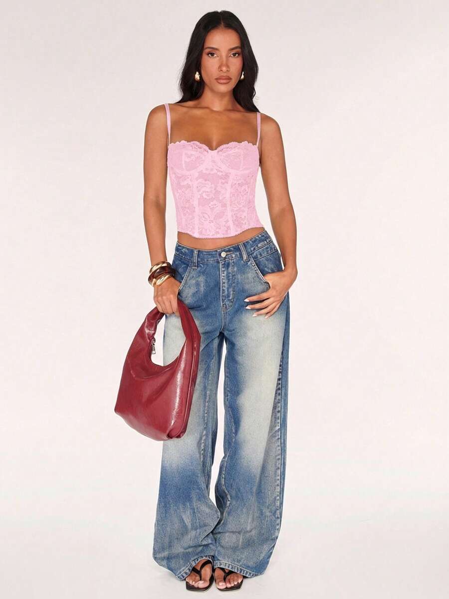 Black women’s lace cami top with spaghetti straps, contrast lace details, and an asymmetrical hem, styled as a slim-fit lined casual top.