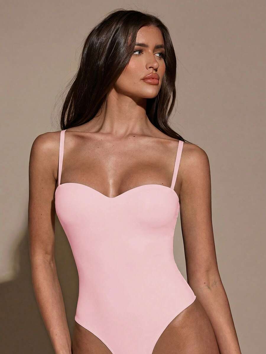 Apricot women's lace sheer camisole top featuring spaghetti straps, contrast lace trim, backless slim fit design, and knitted stretch fabric.