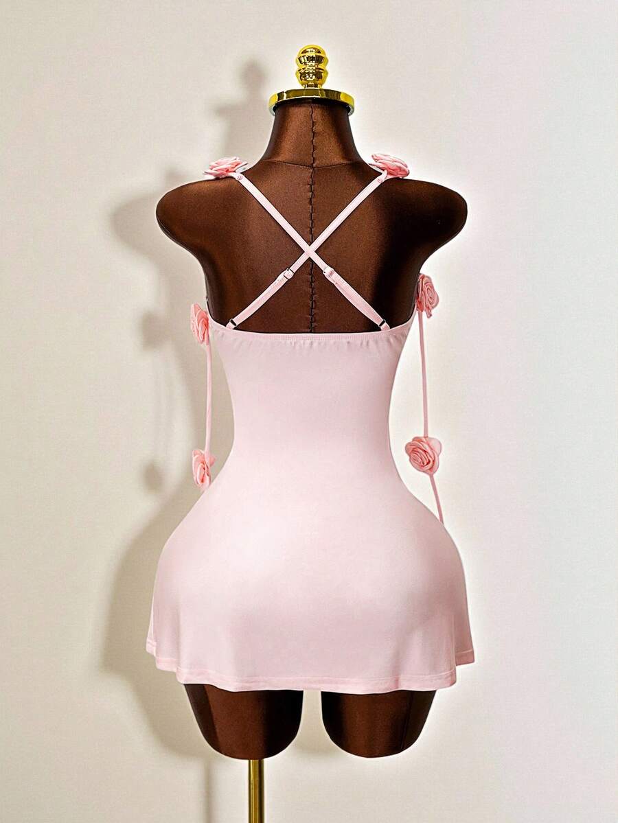 Women's bodycon mini dress featuring a 3D rose accent, thin spaghetti straps, and an open back design.
