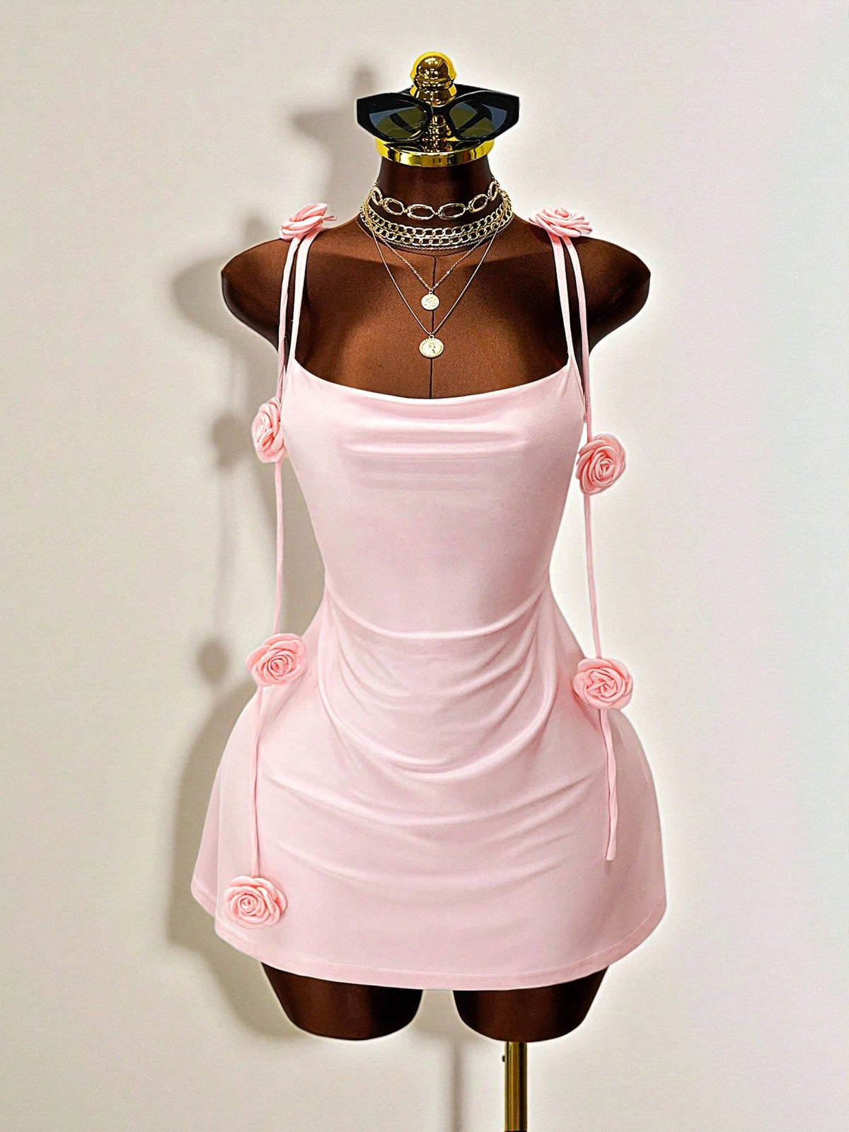 Women's bodycon mini dress featuring a 3D rose accent, thin spaghetti straps, and an open back design.